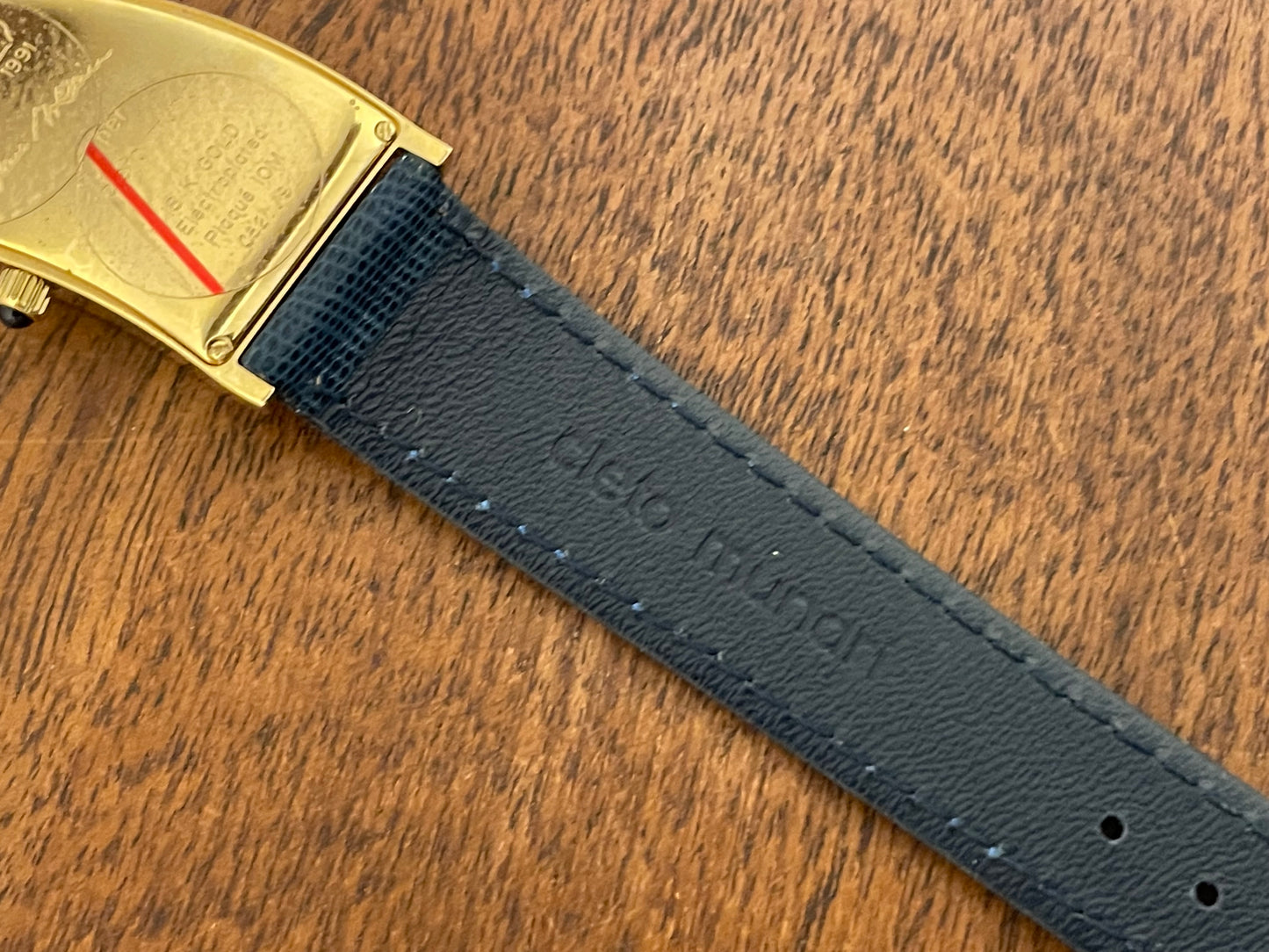 (1991) Cleto Munari "Parentesi" by Hans Hollein - asymmetrical 18K gold electroplated case - blue enamel dial (NOS + full set)