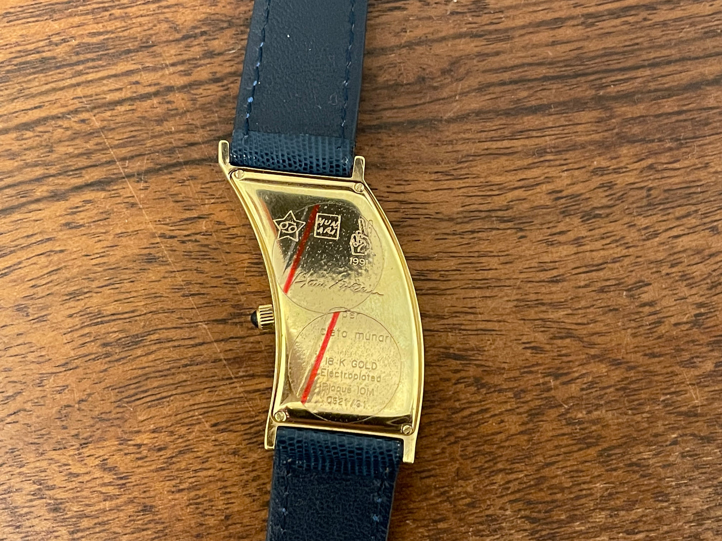 (1991) Cleto Munari "Parentesi" by Hans Hollein - asymmetrical 18K gold electroplated case - blue enamel dial (NOS + full set)