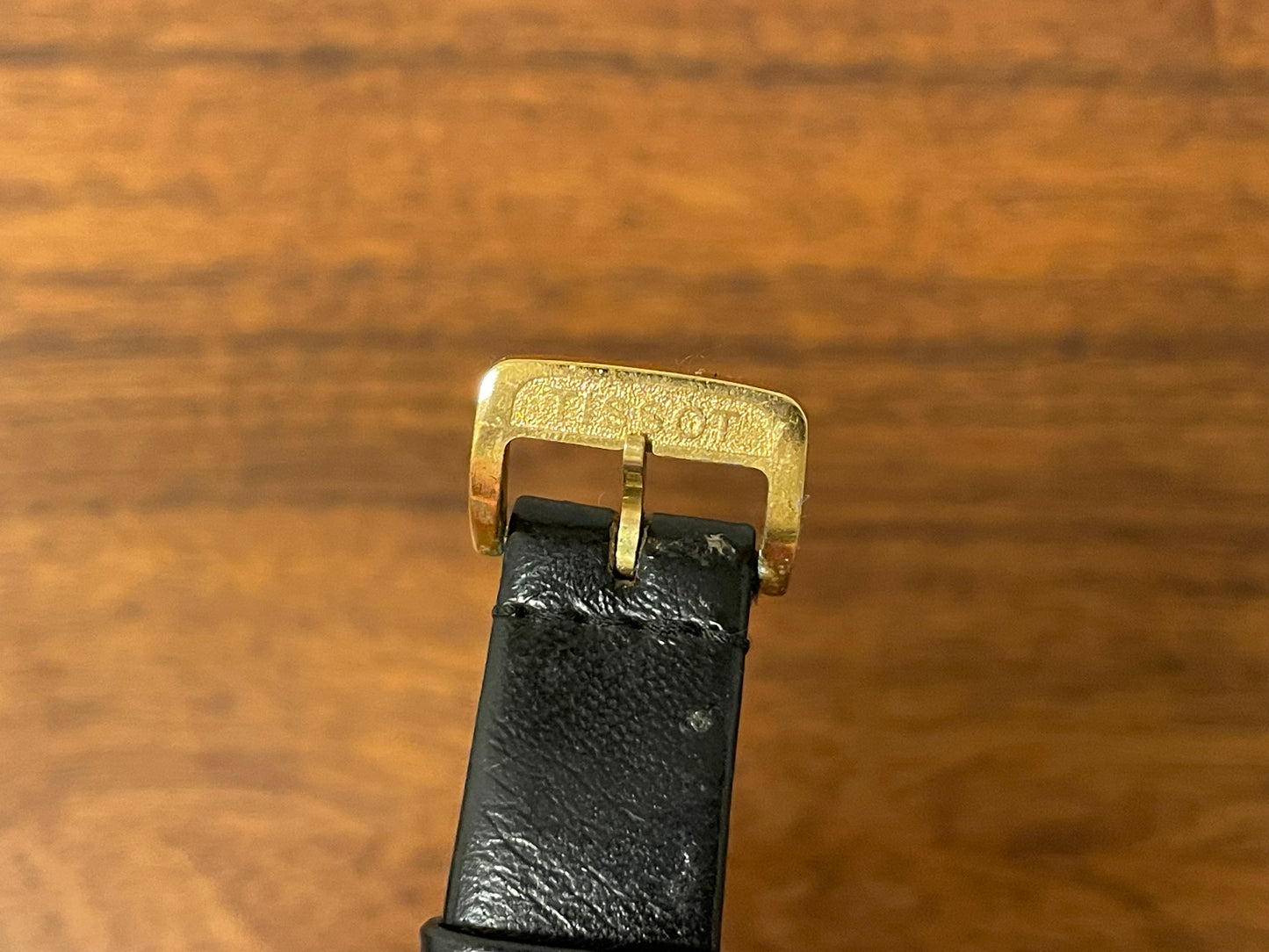 (1970s) Tissot Stylist dress watch - gold case - black dial w/ gold Roman numerals (NOS)