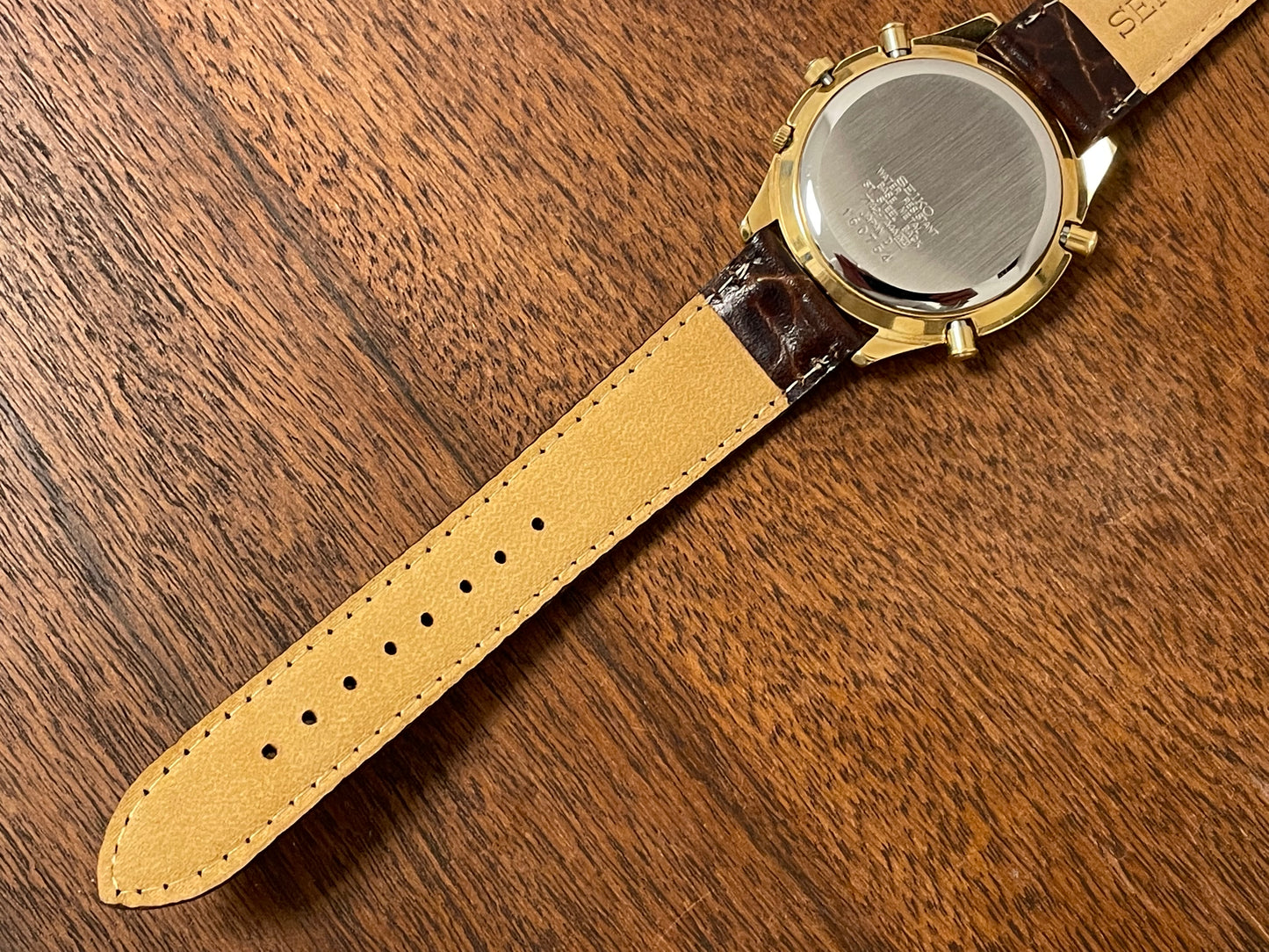 (1991) Seiko 7T42-7A4A “John Player Special” chronograph - gold case, black dial w/ gold markers (NOS)