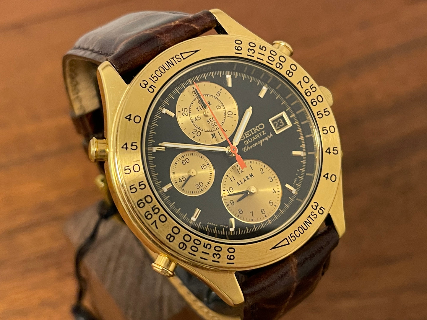 (1991) Seiko 7T42-7A4A “John Player Special” chronograph - gold case, black dial w/ gold markers (NOS)
