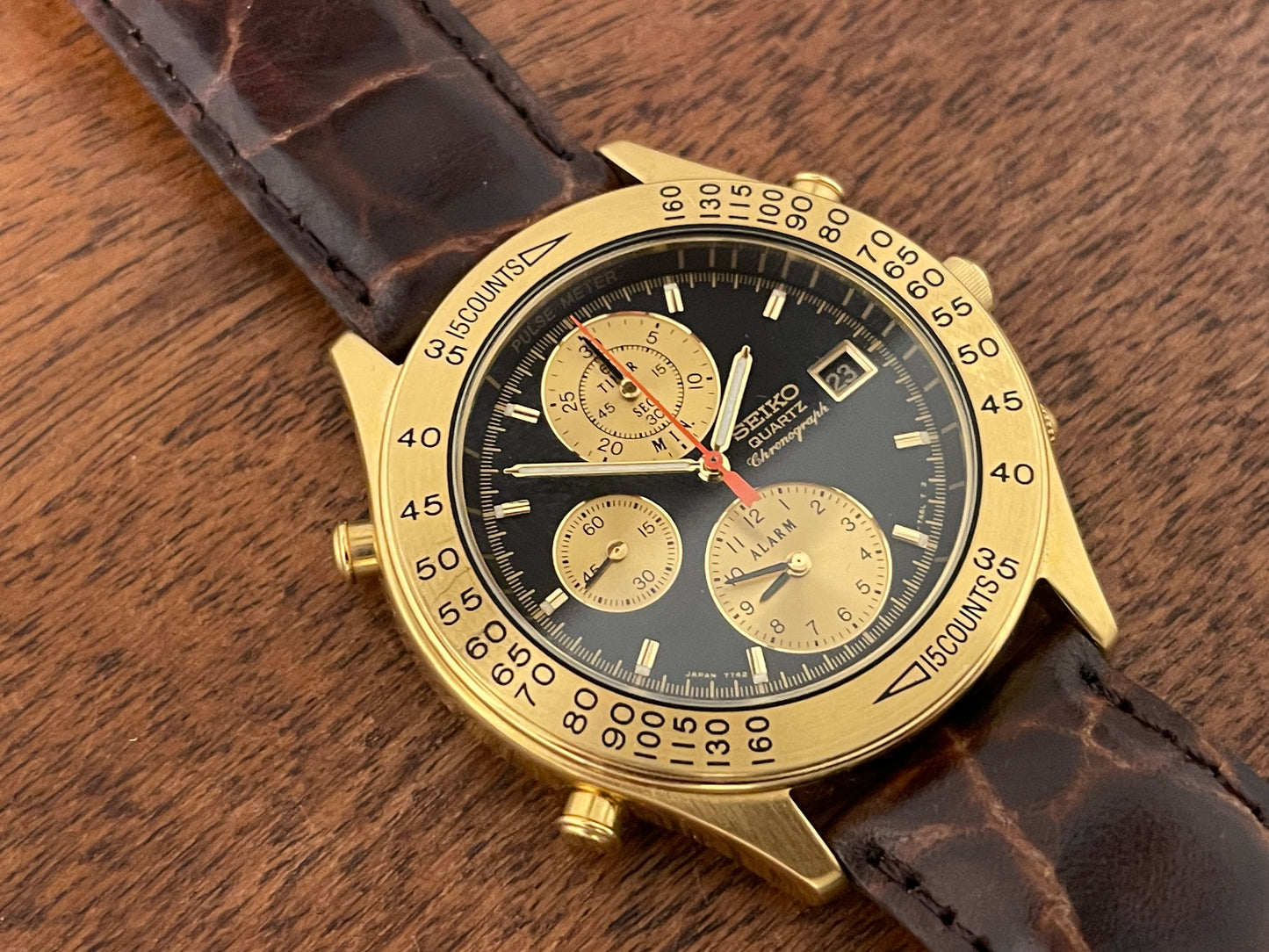 (1991) Seiko 7T42-7A4A “John Player Special” chronograph - gold case, black dial w/ gold markers (NOS)