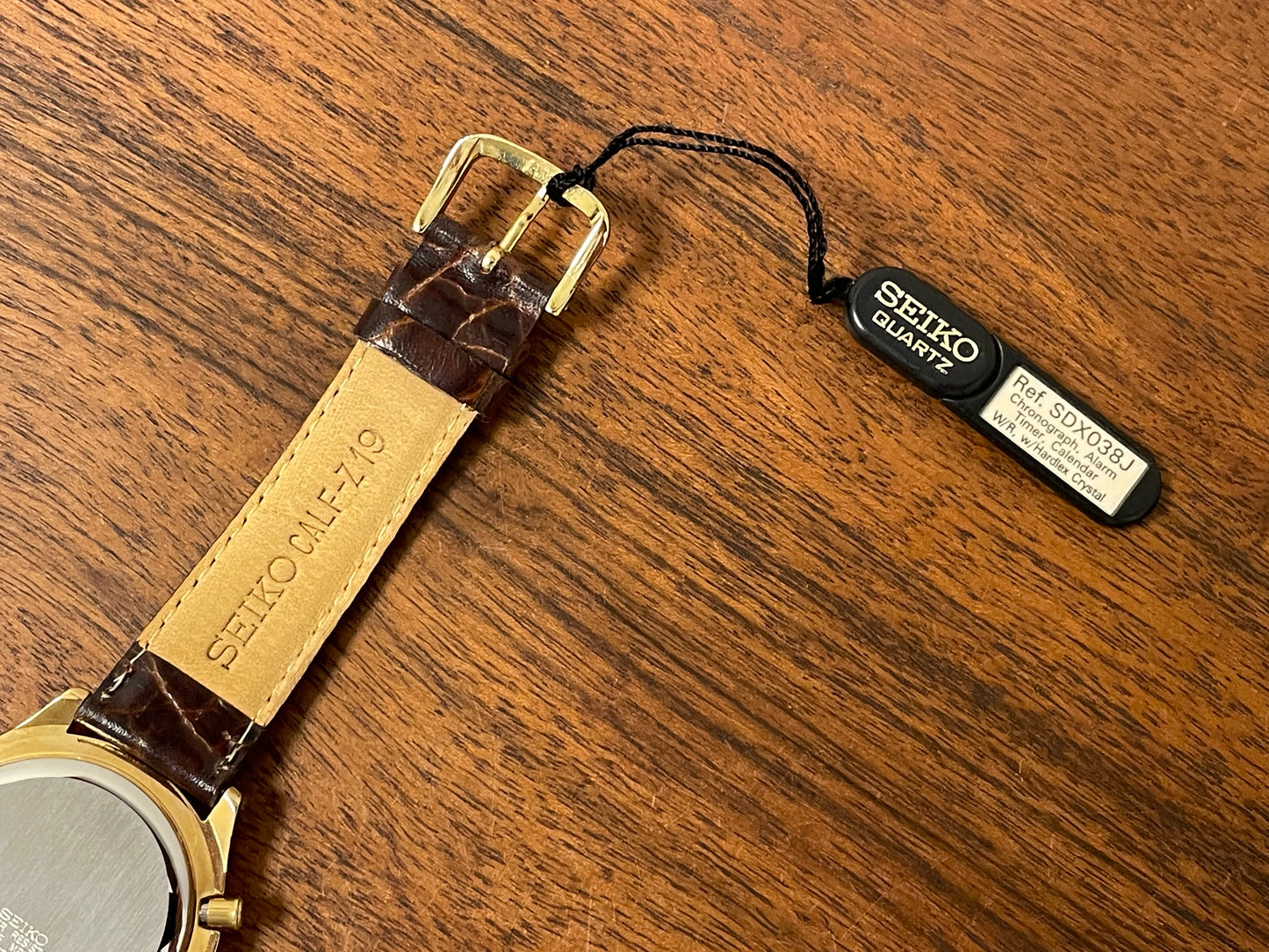 (1991) Seiko 7T42-7A4A “John Player Special” chronograph - gold case, black dial w/ gold markers (NOS)