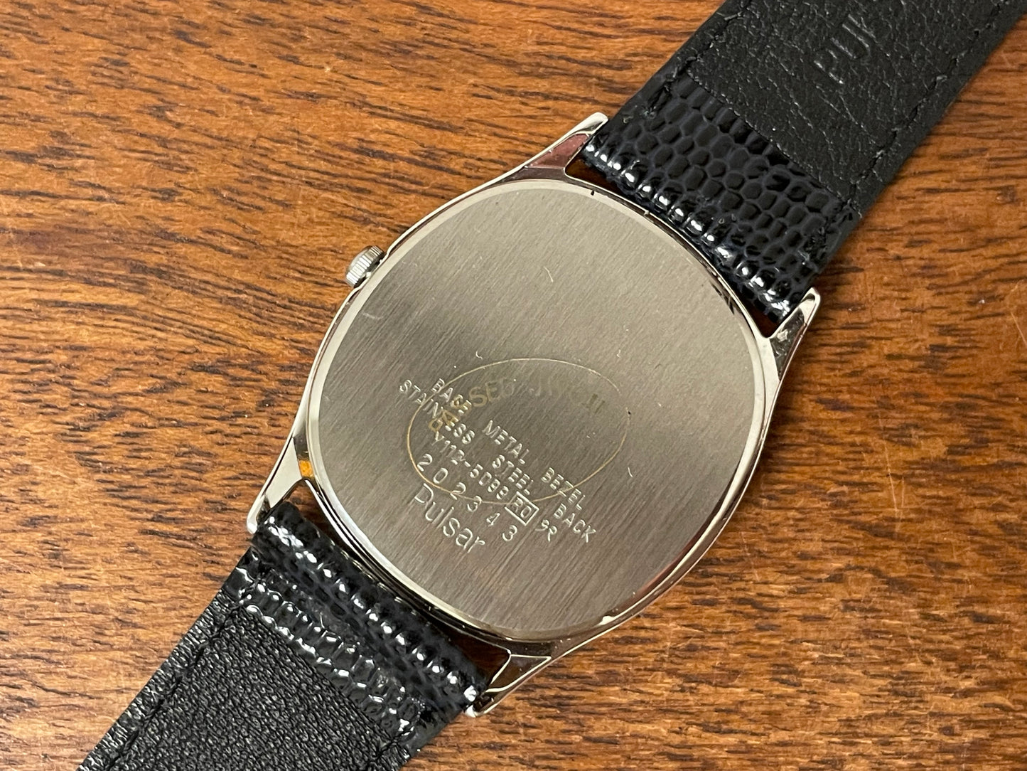 (1982) Pulsar Y112-5099 "Ellipse" dress watch - silver case - black dial w/ silver stick markers (NOS)