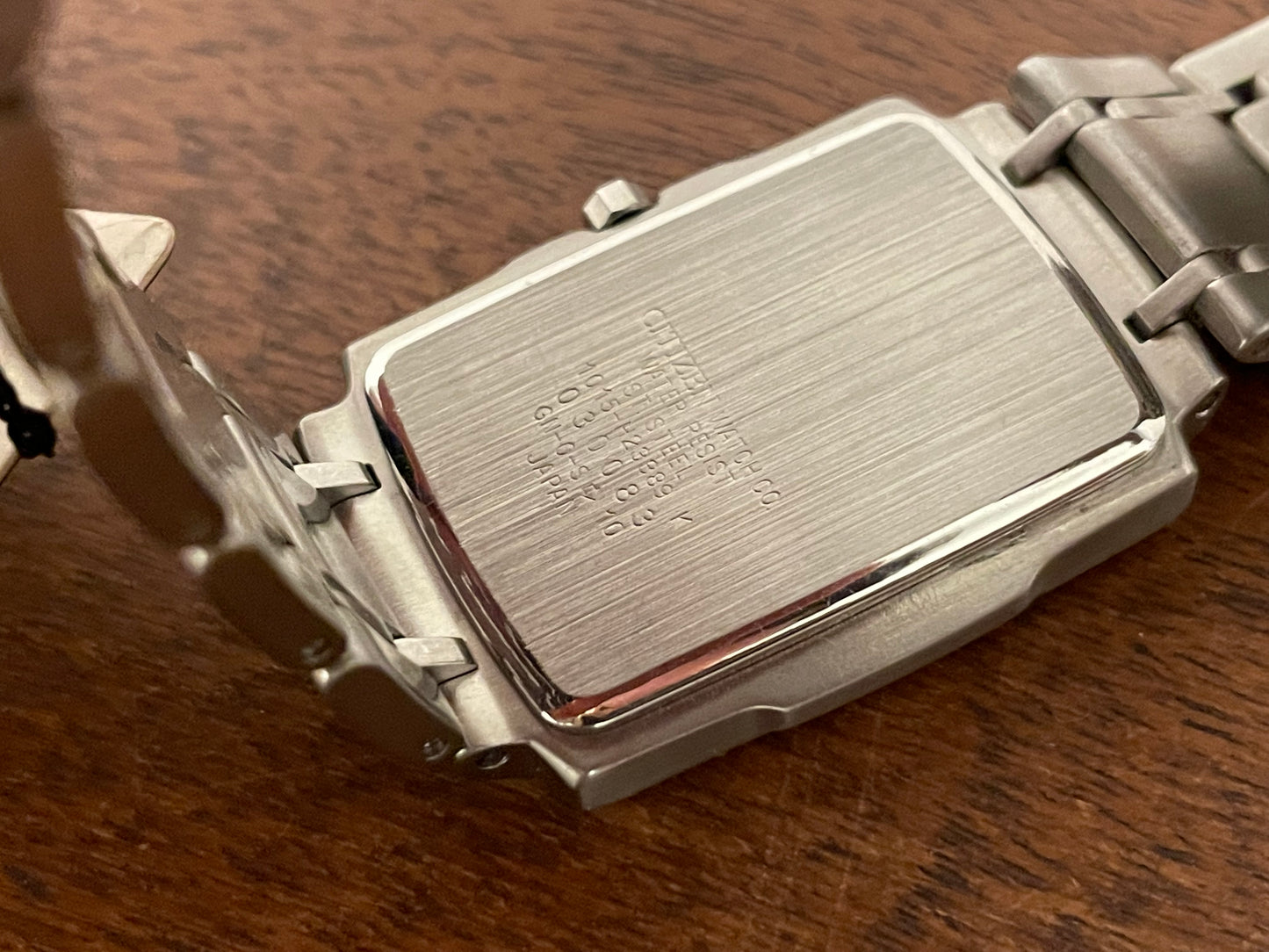 (1990) Citizen 1015-H23389 - integrated bracelet - black dial w/ silver Arabic numerals & markers (NOS)