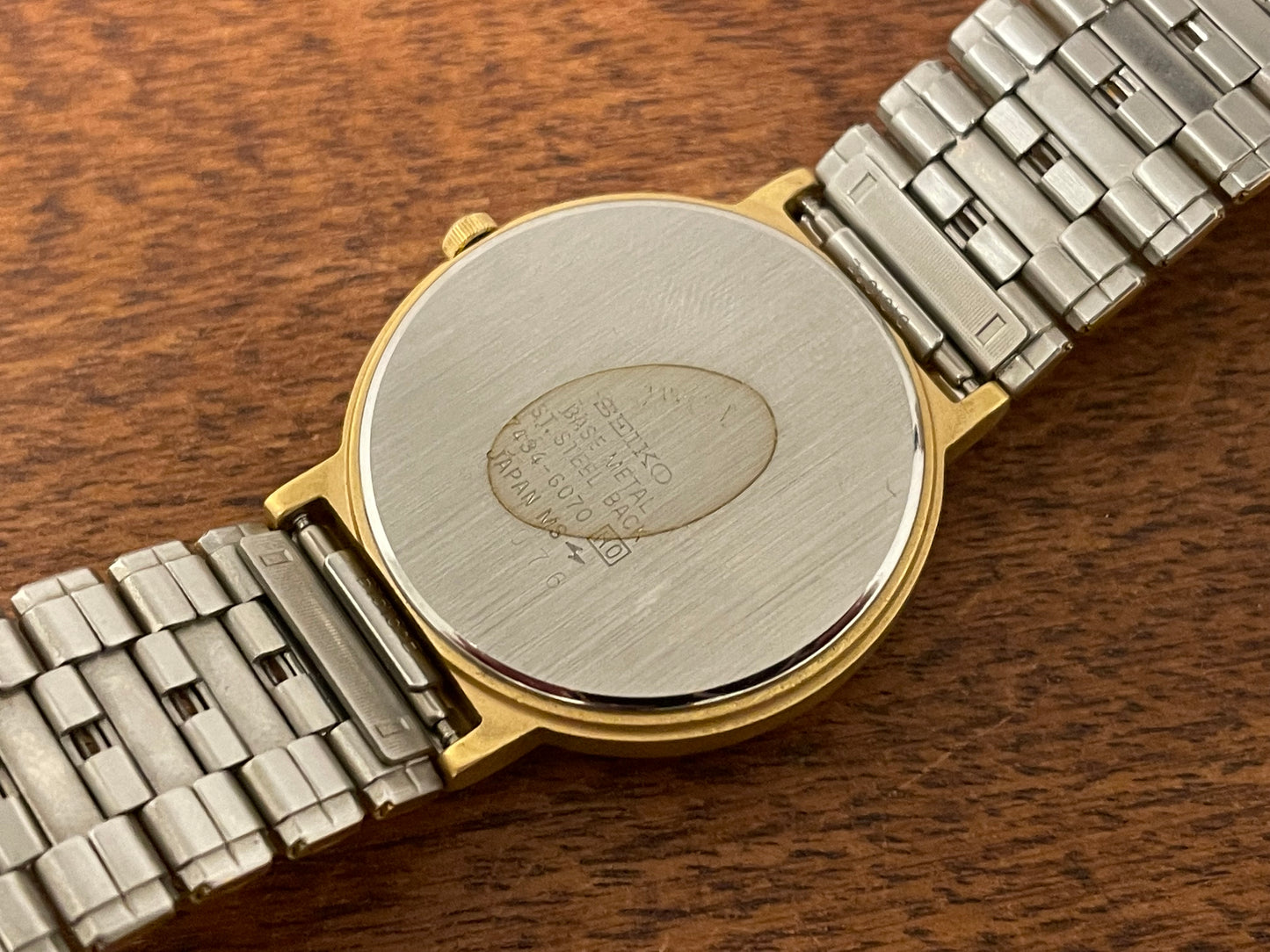 (1986) Seiko 7434-6070 gold colored dress watch - linen dial w/ moon phase