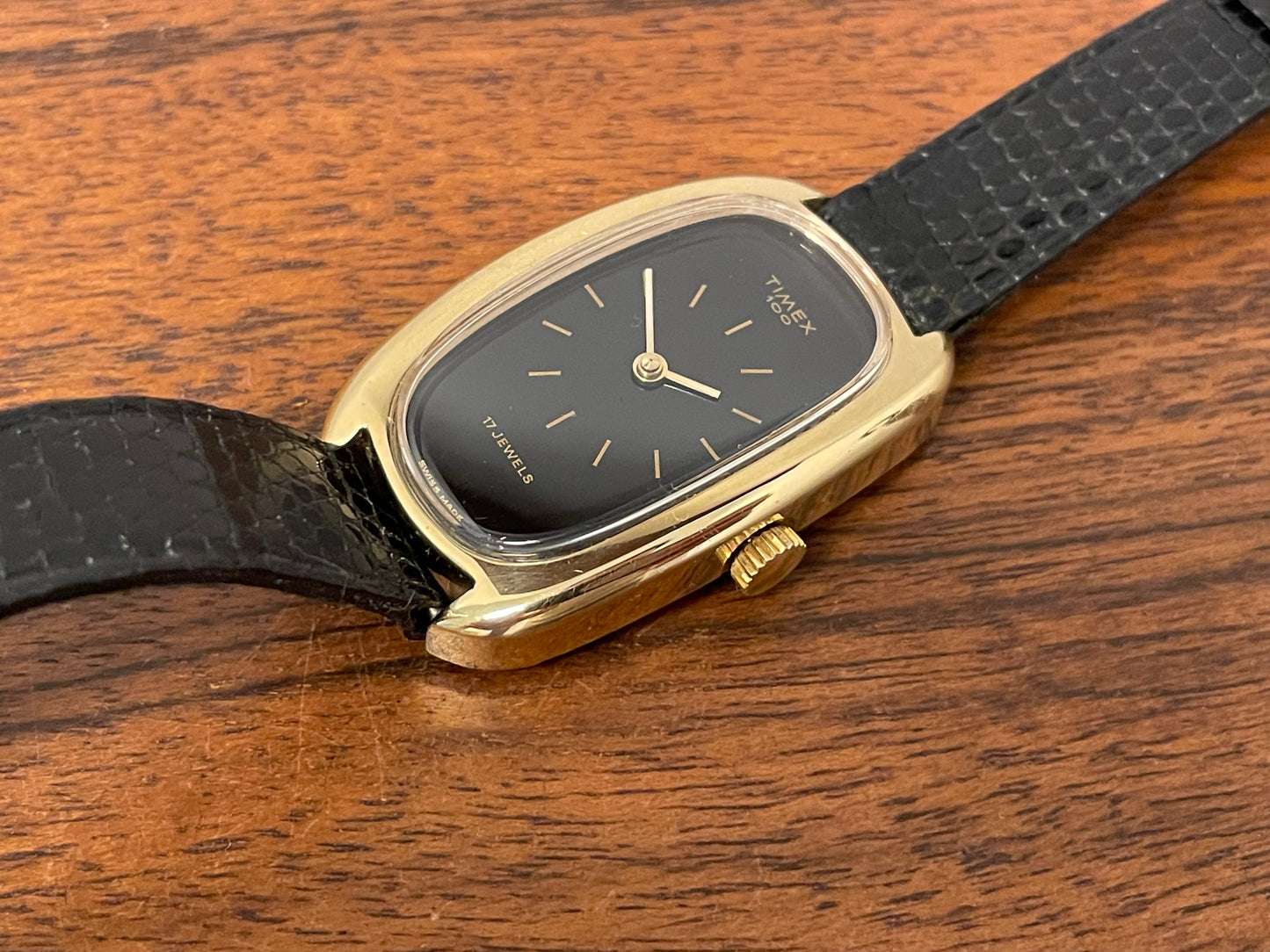 (1979) Timex 100 manual wind dress watch - Swiss made - tonneau case - black dial w/ gold markers
