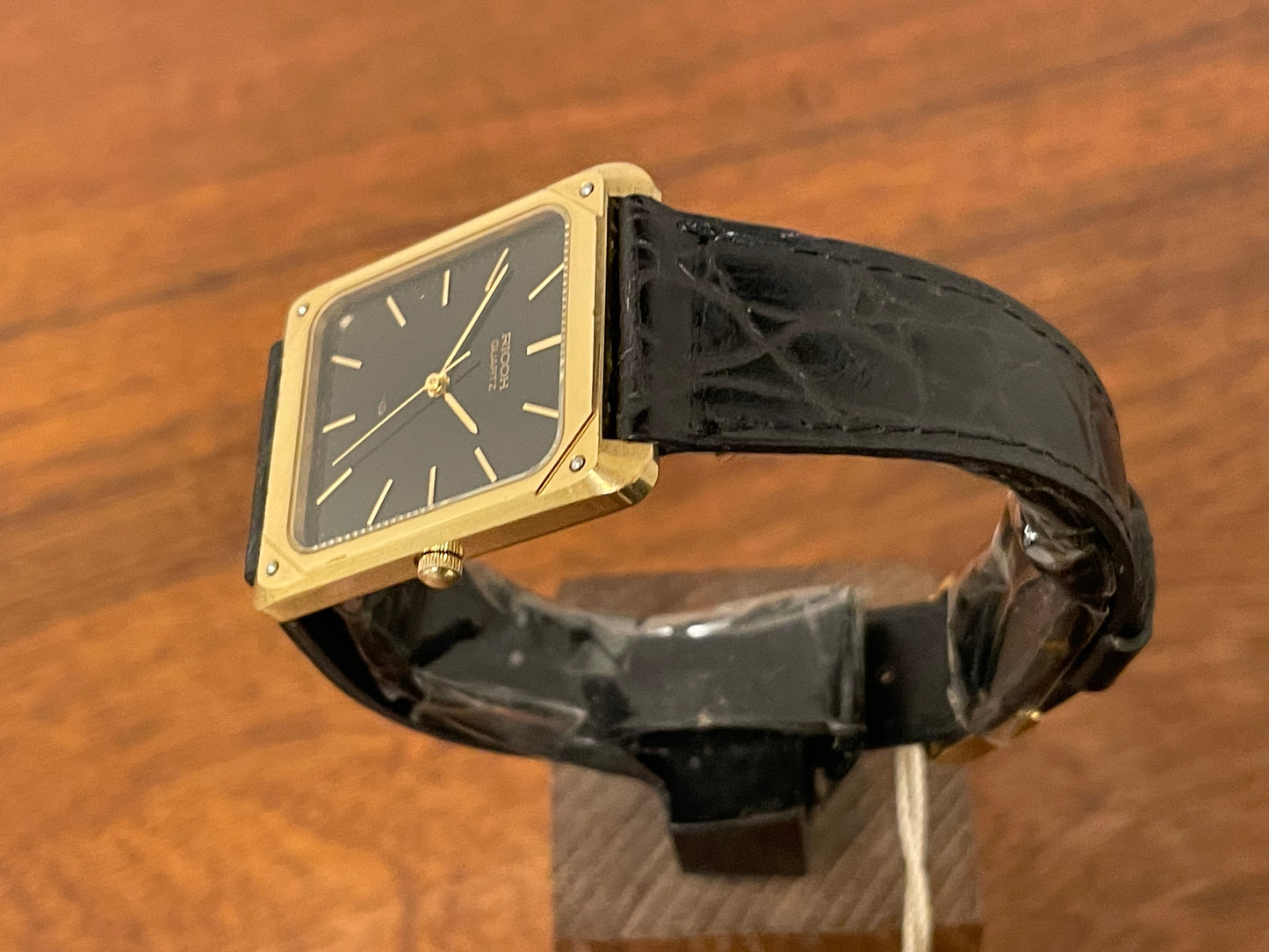 (1977) Ricoh 702009 quartz "Tank" dress watch - black dial w/ gold markers (NOS)