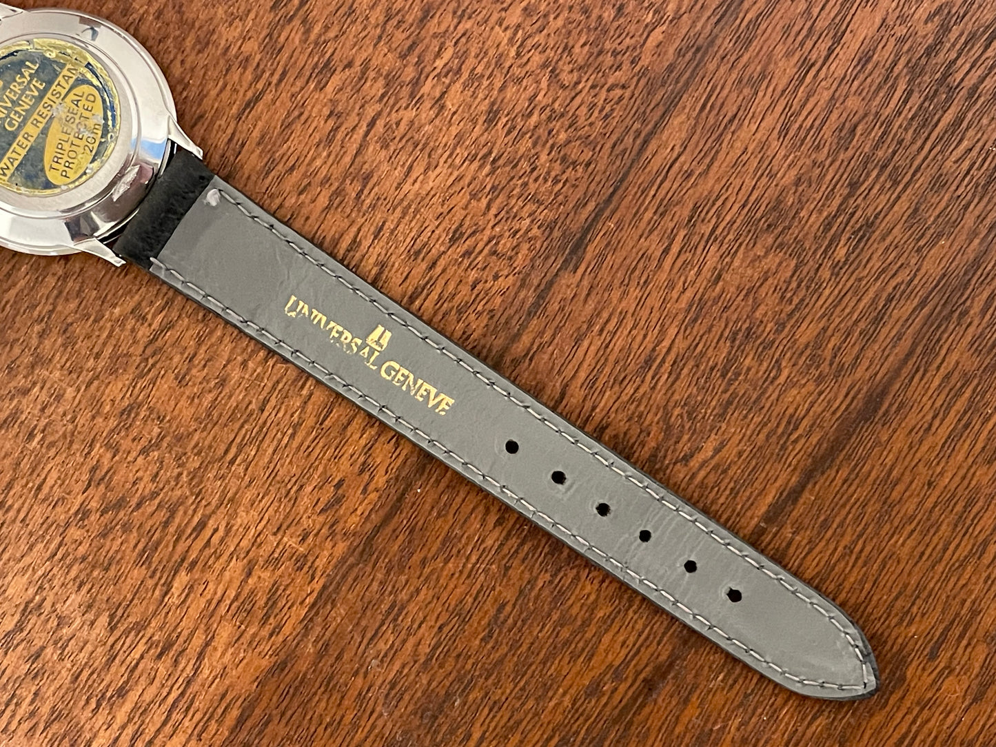(1980s) Universal Genève 6-566 dress watch - silver case w/ gold beaded bezel - grey sunburst dial (NOS)