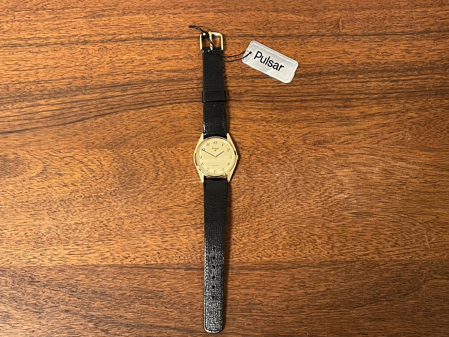 (1991) Pulsar Y480-0460 dress watch - gold colored case - matt champagne dial w/ black Arabic numerals - (NOS)