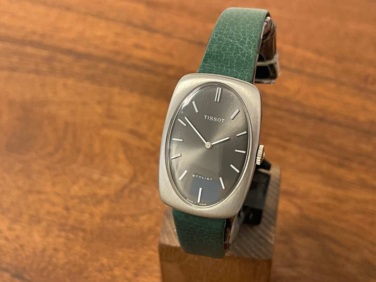 Front side (1970s) Tissot Stylist dress watch - oval grey sunburst dial w/ white stick markers - small size (NOS)