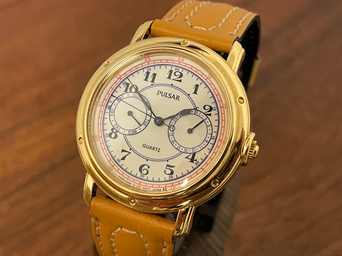 (1988) Pulsar V336-7040 dress watch - gold colored case - creme dial w/ Arabic numerals