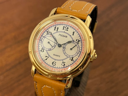 (1988) Pulsar V336-7040 dress watch - gold colored case - creme dial w/ Arabic numerals