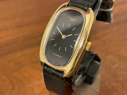 (1979) Timex 100 manual wind dress watch - Swiss made - tonneau case - black dial w/ gold markers