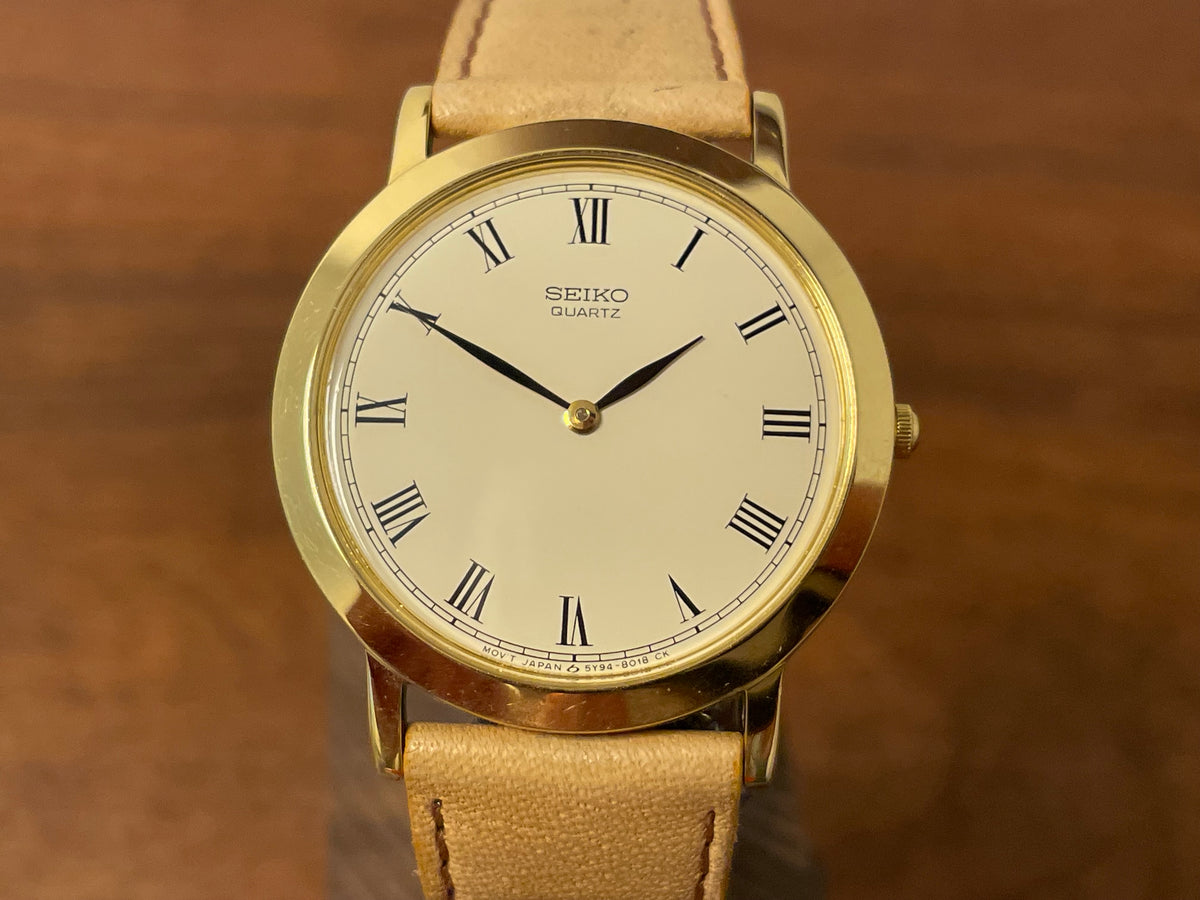 (1989) Seiko 5Y94-8000 dress watch - gold case - cream dial w/ black Roman numerals (NOS)
