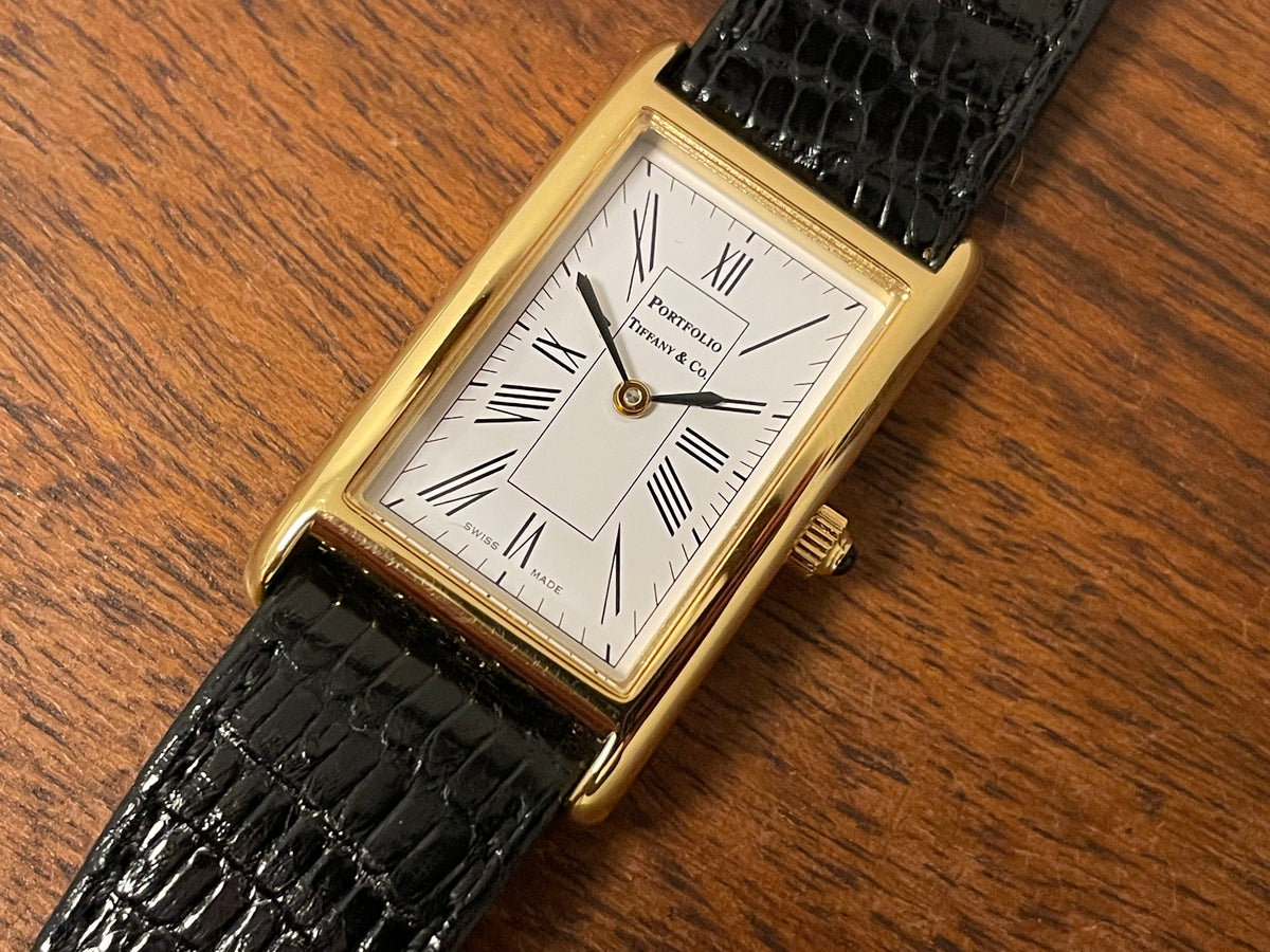 (1998) Tiffany & Co. Portfolio "Tank" dress watch - gold case - white dial w/ black Roman numerals (Mint)