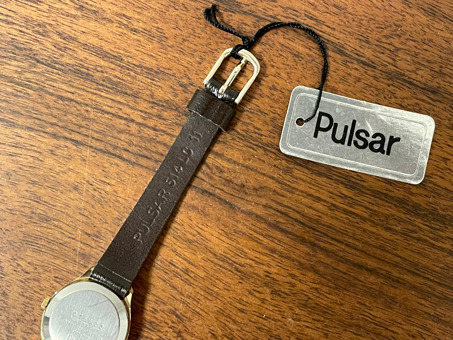 (1990) Pulsar Y480-0060 dress watch - gold colored case - champagne dial w/ black Arabic numerals - small size (NOS)