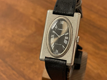 (1970s) Tissot Stylist "Tank" - decorated case - black sunburst dial w/ white Roman numerals - small size (NOS)