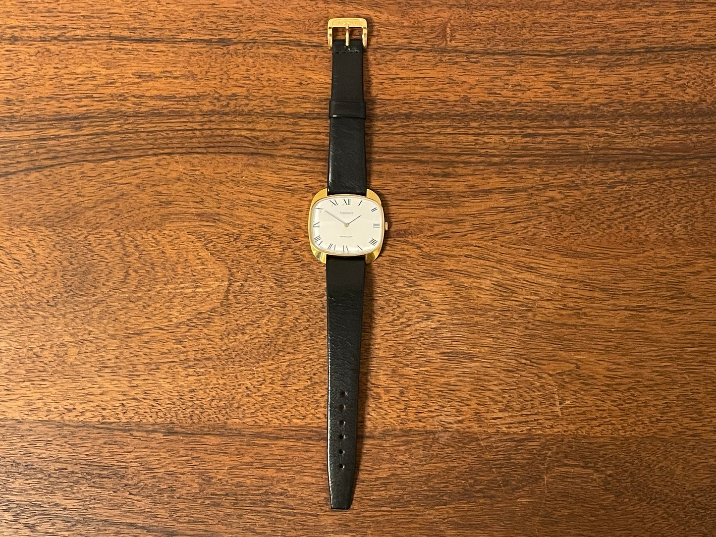 (1970s) Tissot Stylist dress watch - gold “tv case” - white dial w/ black Roman numerals (NOS)