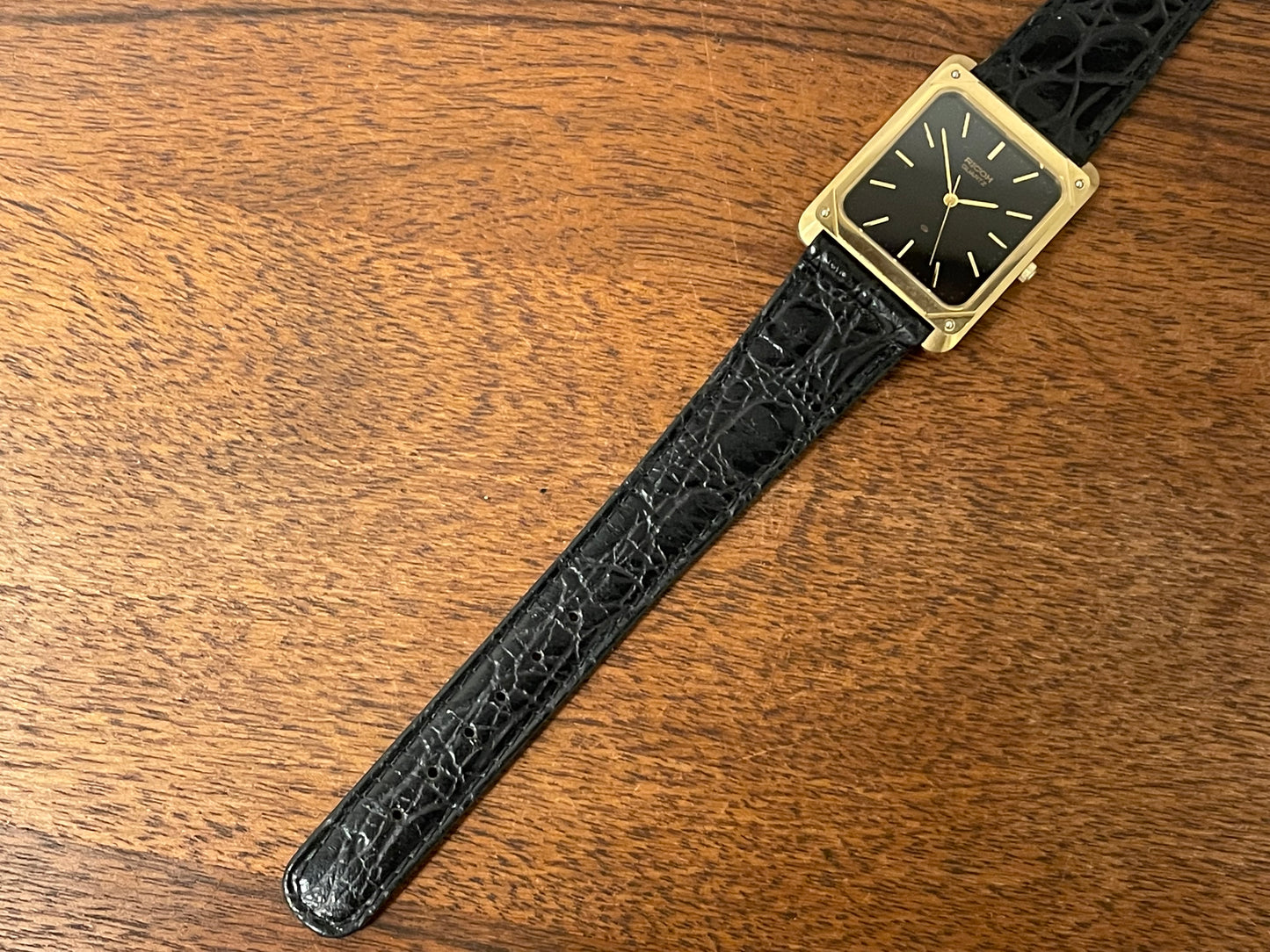 (1977) Ricoh 702009 quartz "Tank" dress watch - black dial w/ gold markers (NOS)