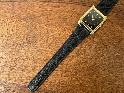 (1977) Ricoh 702009 quartz "Tank" dress watch - black dial w/ gold markers (NOS)