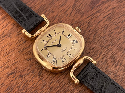 (1980s/1990s) Bulova Paris dress watch - cushion case - gold dial w/ black Roman numerals - small size (NOS)