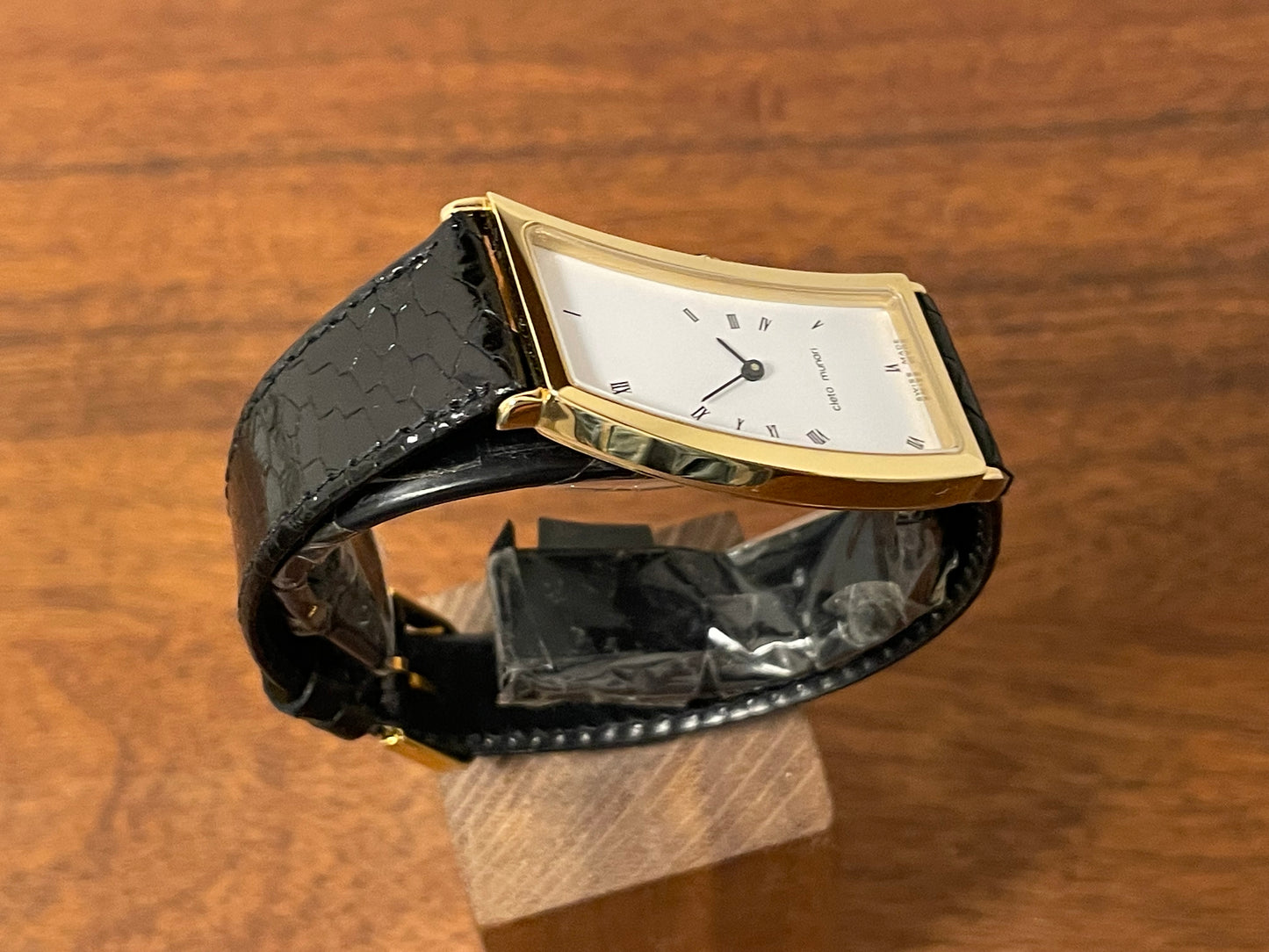 (1988) Cleto Munari "Parentesi" by Hans Hollein - asymmetrical 18K gold electroplated case - white dial w/ Roman numerals  (NOS + full set)