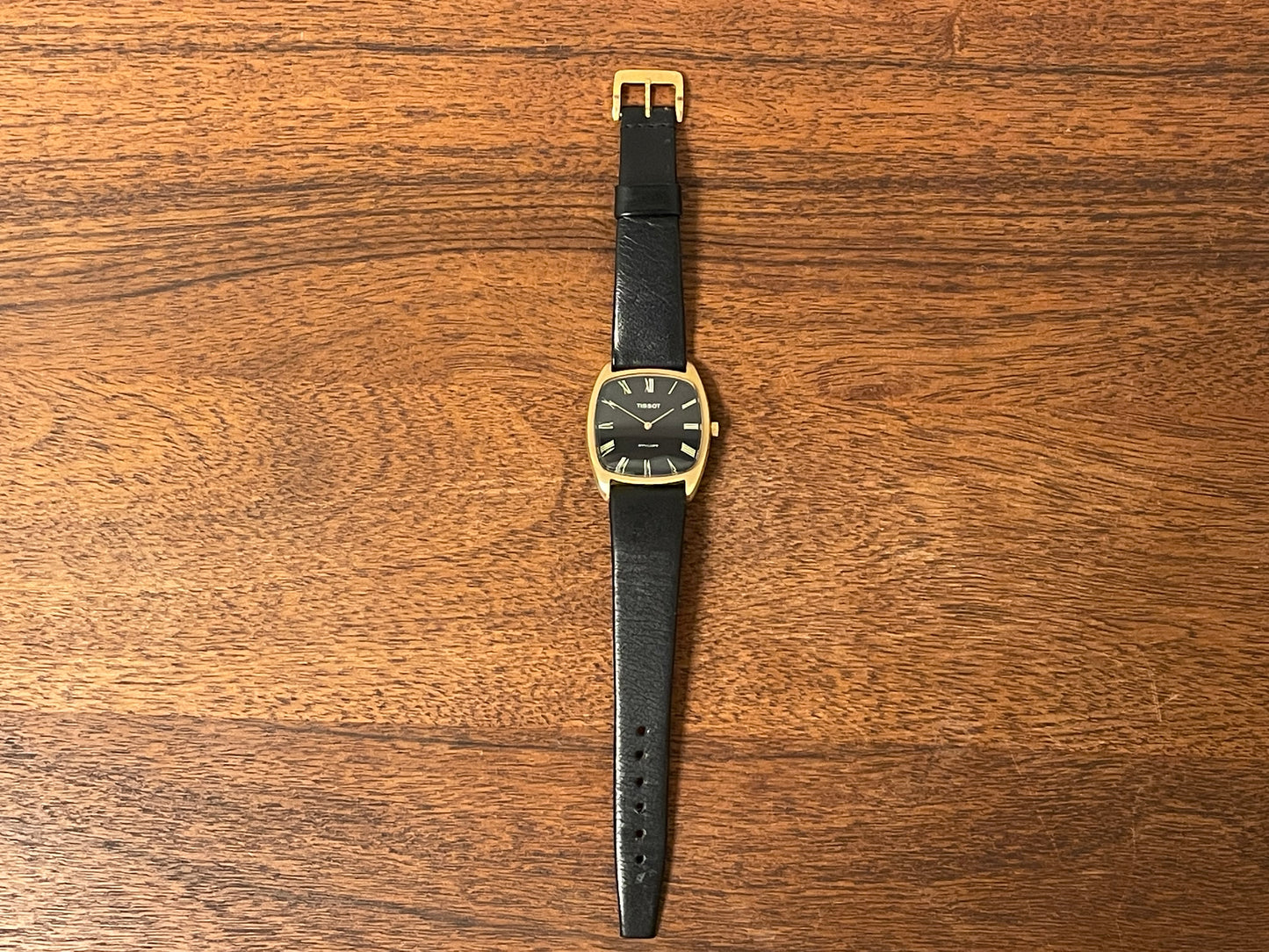 (1970s) Tissot Stylist dress watch - gold case - black dial w/ gold Roman numerals (NOS)
