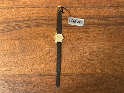 (1990) Pulsar Y480-0060 dress watch - gold colored case - champagne dial w/ black Arabic numerals - small size (NOS)
