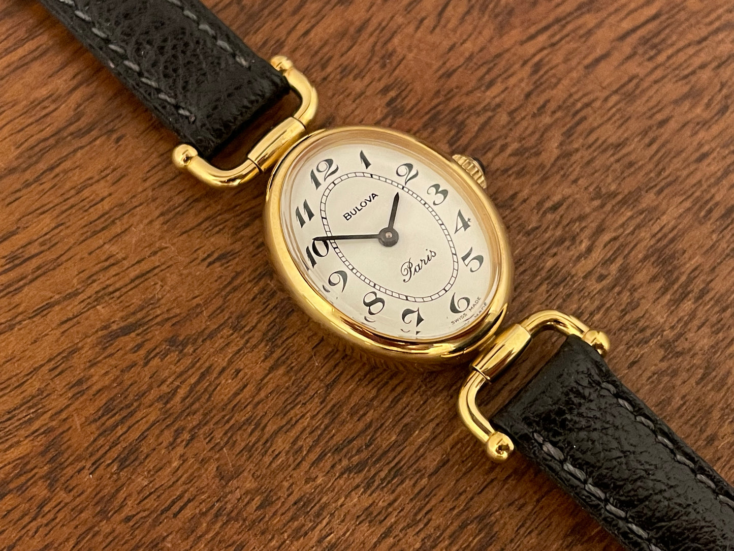 (1980s/1990s) Bulova Paris dress watch - oval case - cream dial w/ black Arabic numerals - small size (NOS)