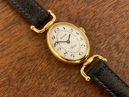 (1980s/1990s) Bulova Paris dress watch - oval case - cream dial w/ black Arabic numerals - small size (NOS)