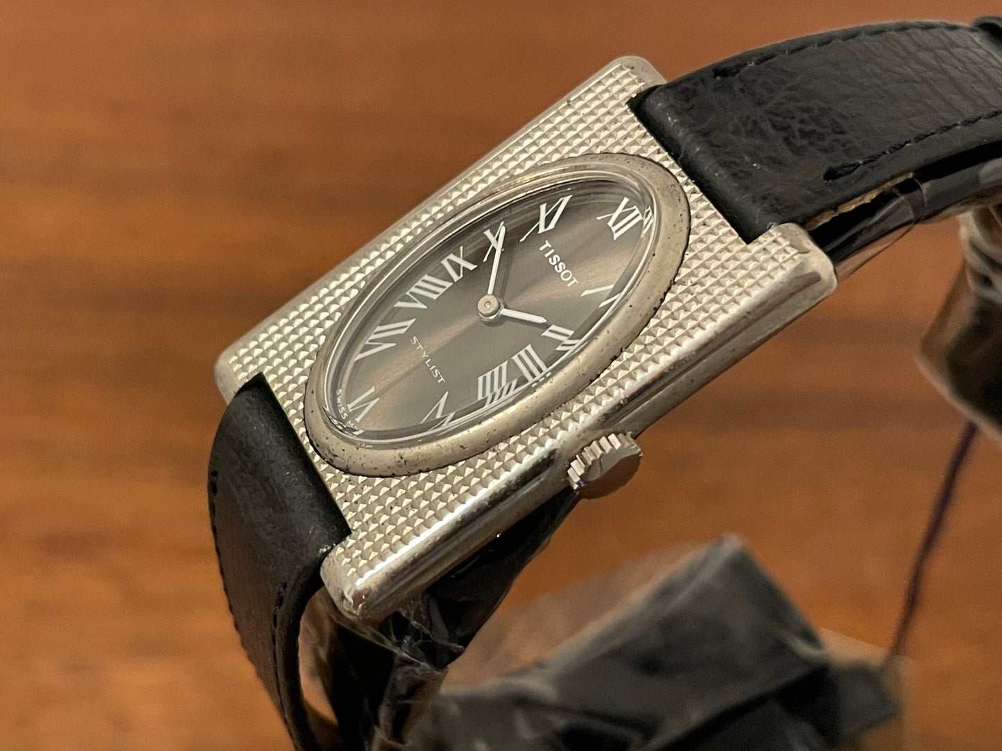(1970s) Tissot Stylist "Tank" - decorated case - black sunburst dial w/ white Roman numerals - small size (NOS)