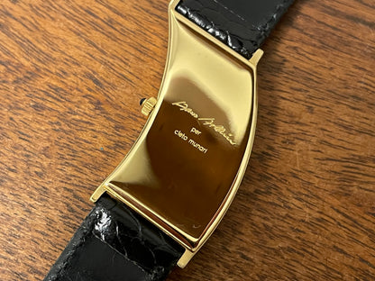 (1988) Cleto Munari "Parentesi" by Hans Hollein - asymmetrical 18K gold electroplated case - white dial w/ Roman numerals  (NOS + full set)