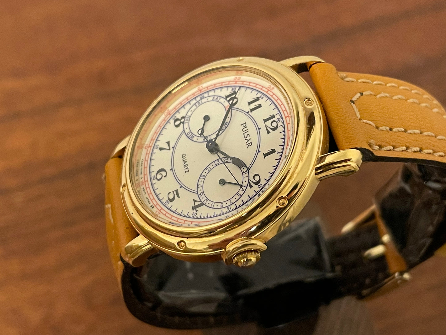 (1988) Pulsar V336-7040 dress watch - gold colored case - creme dial w/ Arabic numerals