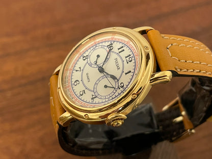 (1988) Pulsar V336-7040 dress watch - gold colored case - creme dial w/ Arabic numerals