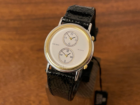 front side (1985) Seiko 1E20-0160 dual time dress watch - round case - white dial w/ 2 subdials  (NOS)