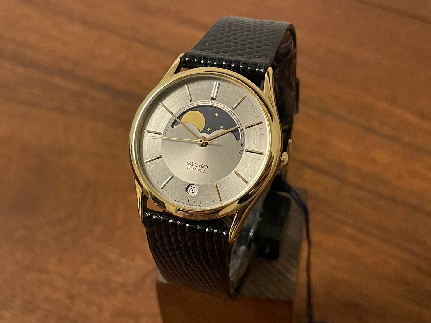 Front side (1986) Seiko 7434-7000 dress watch with moon phase -silver dial w/ gold stick markers (NOS)