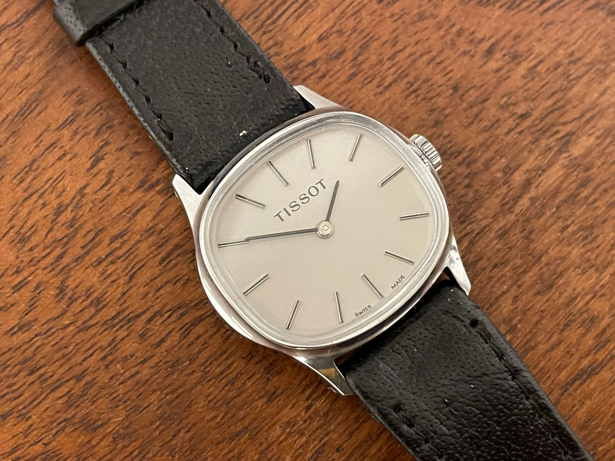 (1970s) Tissot 052-15007 Stylist dress watch - silver cushion case - silver brushed dial w/ silver stick markers - small size (NOS)