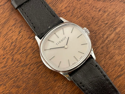 (1970s) Tissot 052-15007 Stylist dress watch - silver cushion case - silver brushed dial w/ silver stick markers - small size (NOS)