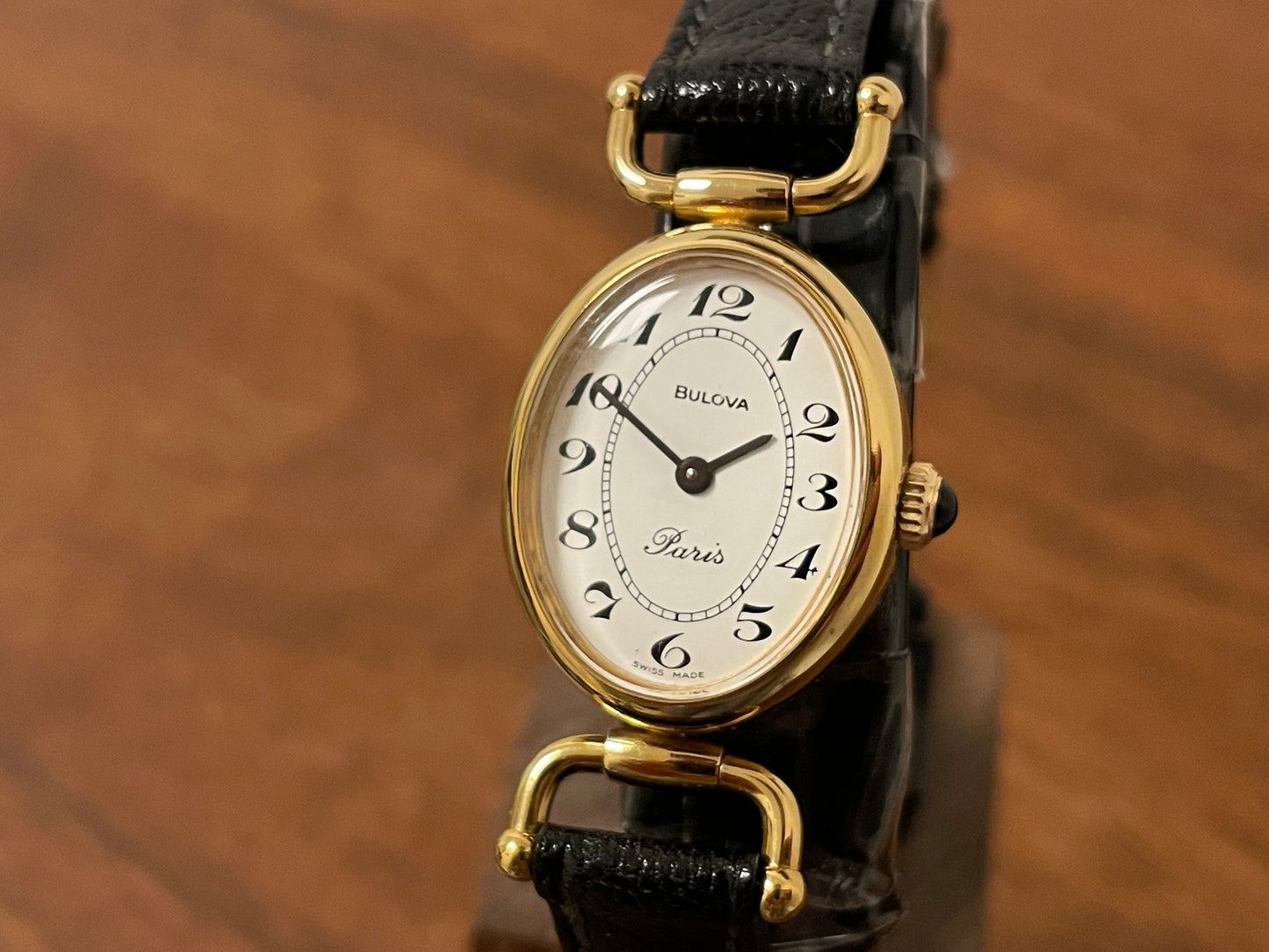 (1980s/1990s) Bulova Paris dress watch - oval case - cream dial w/ black Arabic numerals - small size (NOS)
