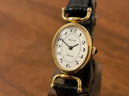 (1980s/1990s) Bulova Paris dress watch - oval case - cream dial w/ black Arabic numerals - small size (NOS)