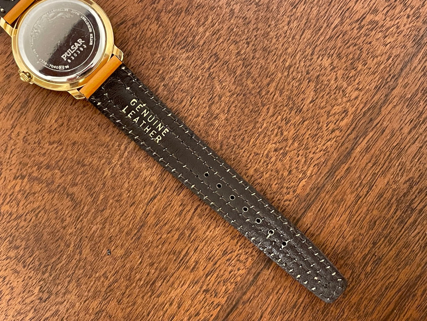 (1988) Pulsar V336-7040 dress watch - gold colored case - creme dial w/ Arabic numerals