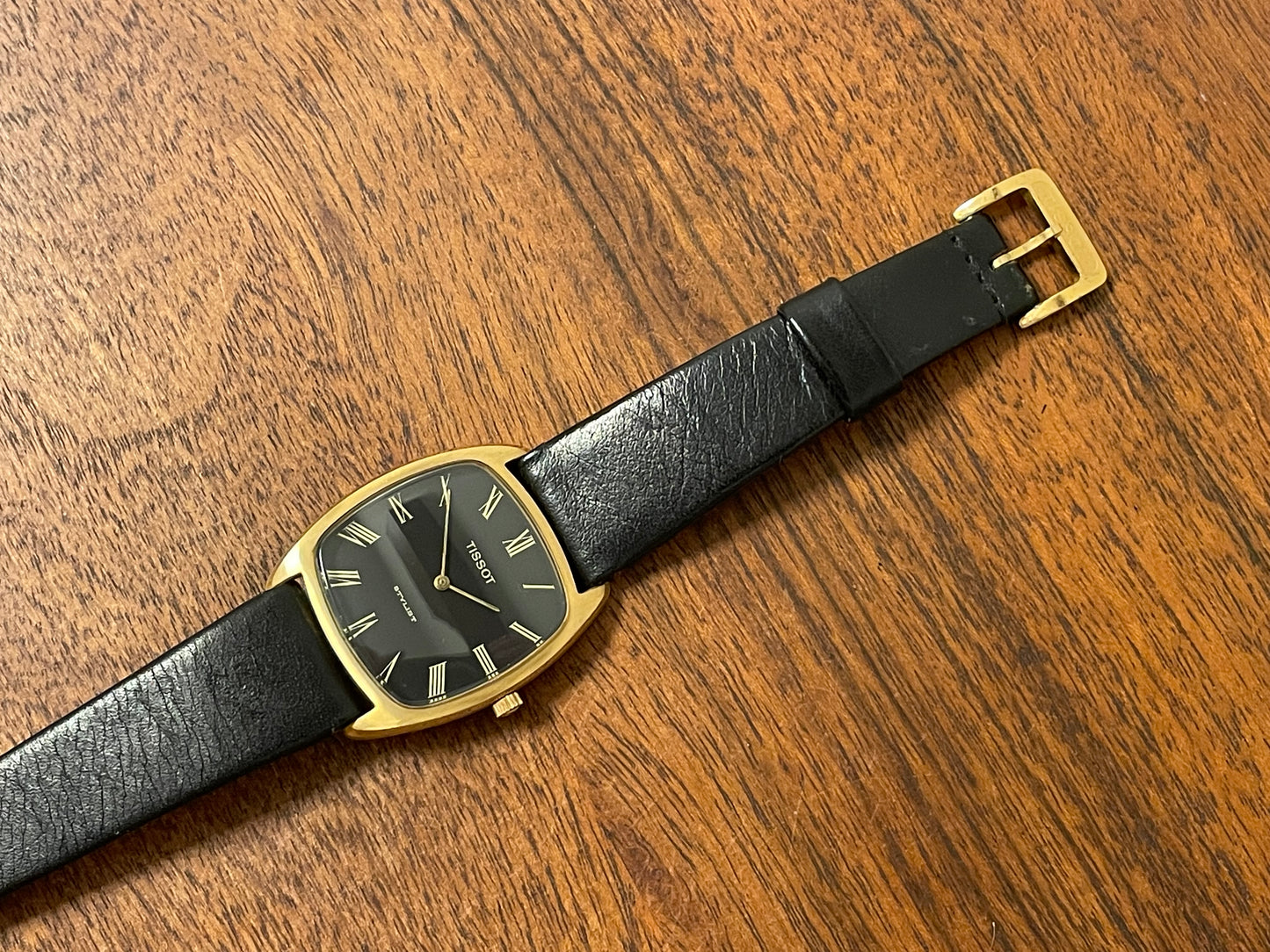 (1970s) Tissot Stylist dress watch - gold case - black dial w/ gold Roman numerals (NOS)
