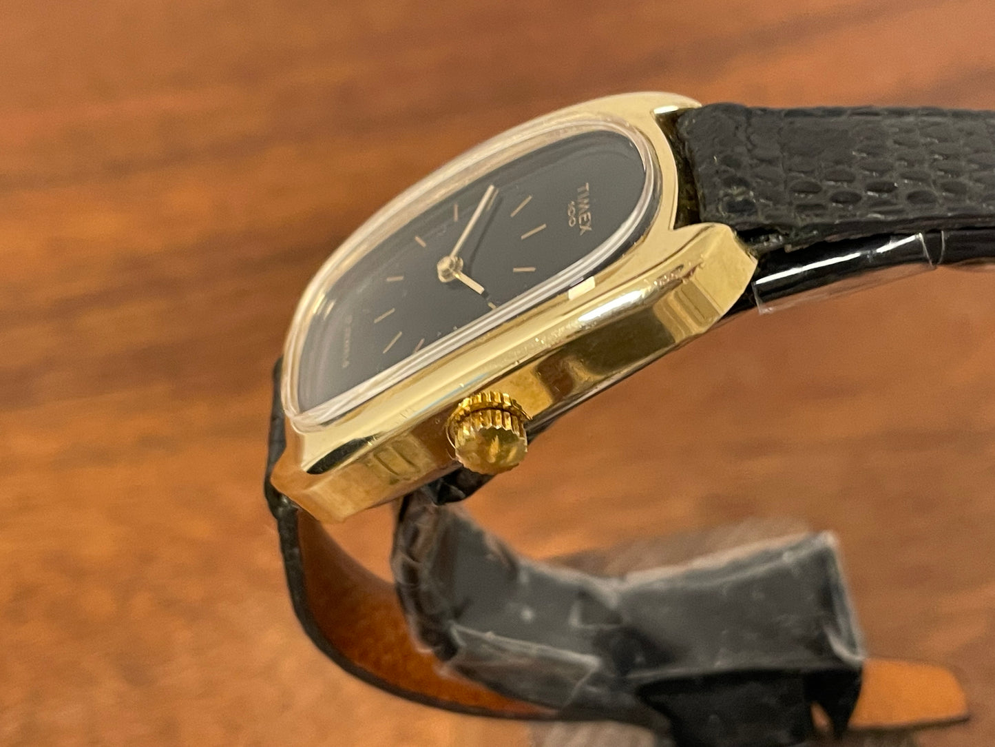 (1979) Timex 100 manual wind dress watch - Swiss made - tonneau case - black dial w/ gold markers