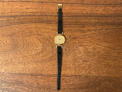 (1980s/1990s) Bulova Paris dress watch - cushion case - gold dial w/ black Roman numerals - small size (NOS)