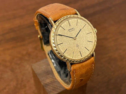 (1977) Seiko 43-0150 14K solid gold dress watch - rope bezel -  gold textured dial w/ gold markers
