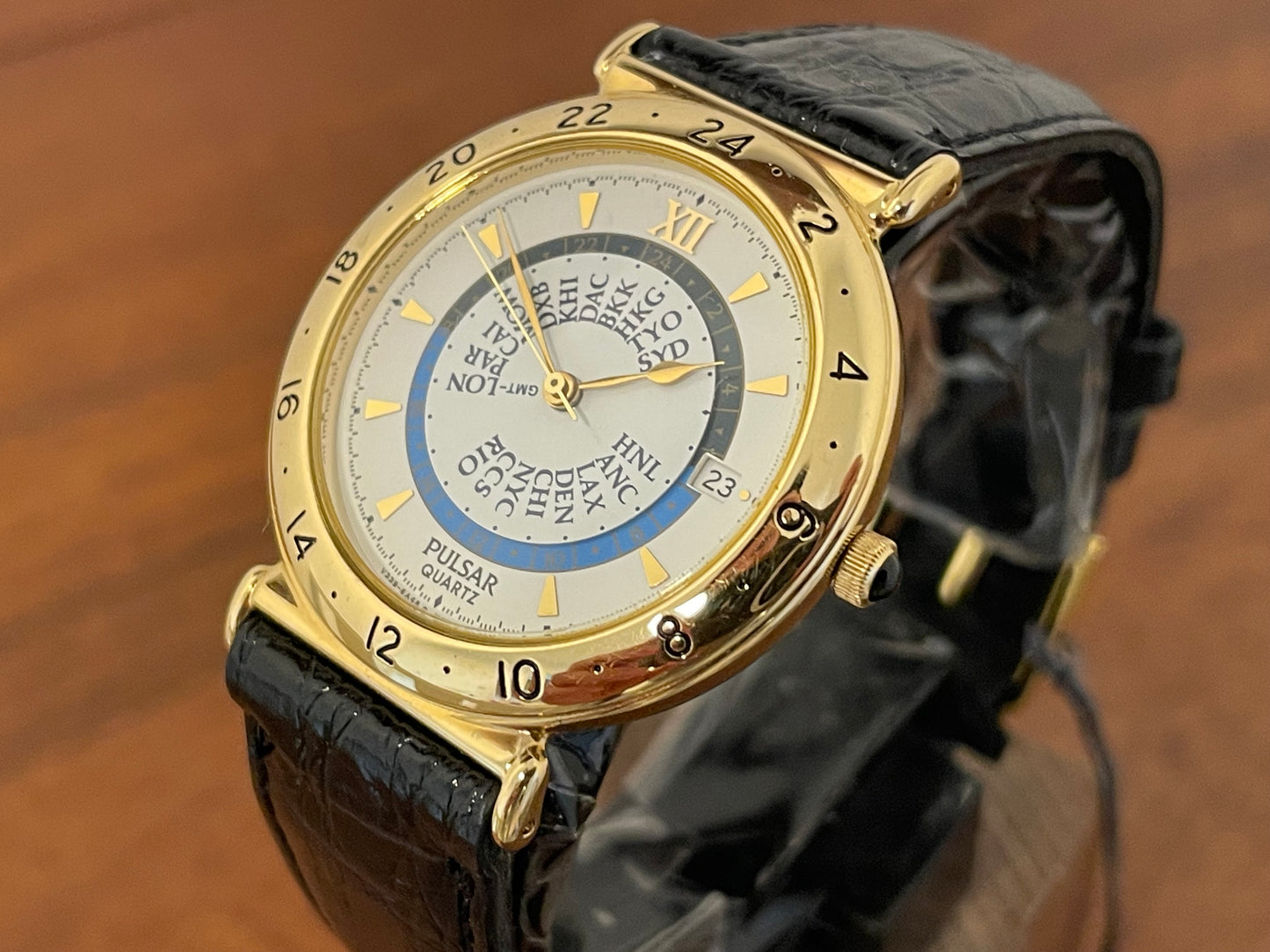 (1999) Pulsar V339-6000 world Timer - gold case - rotating white dial w/ gold markers (NOS)