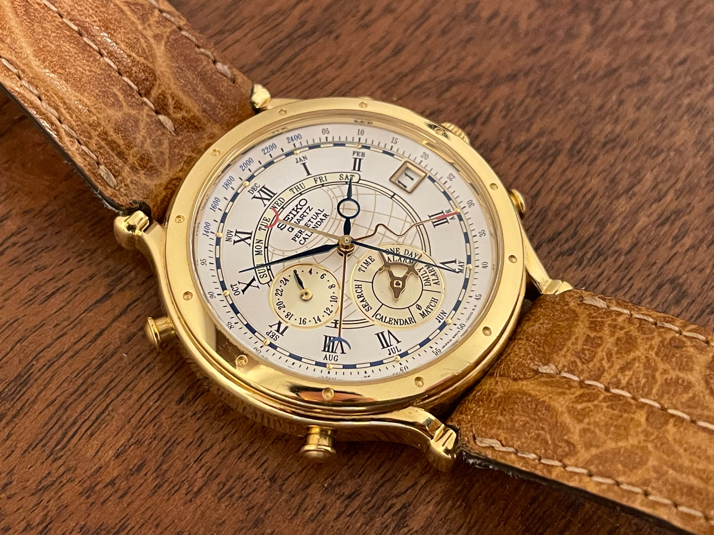 (1994) Seiko 6m13-0010 Age of Discovery (AOD) Perpetual Calendar - gold colored case - white dial w/ black Roman numerals