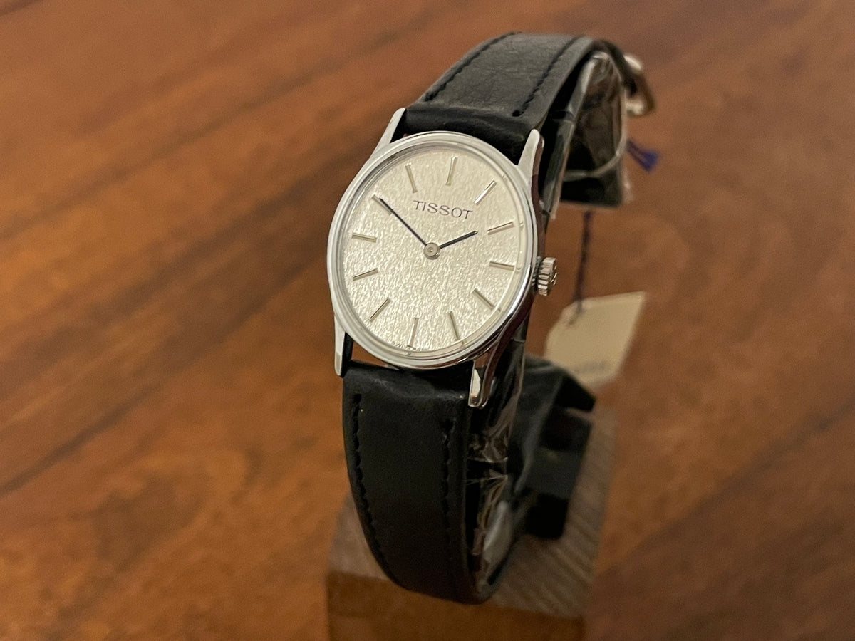 Front side (1970s) Tissot 052-10991 Stylist dress watch - silver oval case - silverdust dial w/ silver stick markers - small size (NOS)