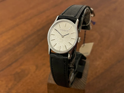 Front side (1970s) Tissot 052-10991 Stylist dress watch - silver oval case - silverdust dial w/ silver stick markers - small size (NOS)
